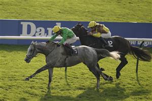 NEWMARKET, ENGLAND - OCTOBER 09: Oisin Murphy riding Buzz (green) win The Together For Racing International Cesarewitch Handicap at Newmarket Racecourse on October 09, 2021 in Newmarket, England. (Photo by Alan Crowhurst/Getty Images)