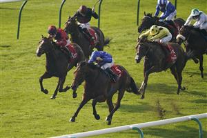 NEWMARKET, ENGLAND - OCTOBER 09: William Buick riding Coroebus (blue) win The Emirates Autumn Stakes at Newmarket Racecourse on October 09, 2021 in Newmarket, England. (Photo by Alan Crowhurst/Getty Images)