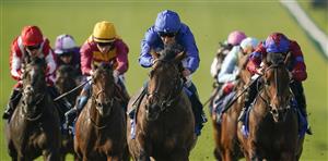 NEWMARKET, ENGLAND - OCTOBER 09: William Buick riding Native Trail (C, blue) win The Darley Dewhurst Stakes at Newmarket Racecourse on October 09, 2021 in Newmarket, England. (Photo by Alan Crowhurst/Getty Images)