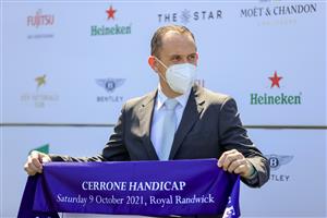 SYDNEY, AUSTRALIA - OCTOBER 09: Trainer Chris Waller holds up the sash after winning race 3 the Cerrone Handicap with Yiyi during Sydney Racing at Royal Randwick Racecourse on October 09, 2021 in Sydney, Australia. (Photo by Mark Evans/Getty Images)
